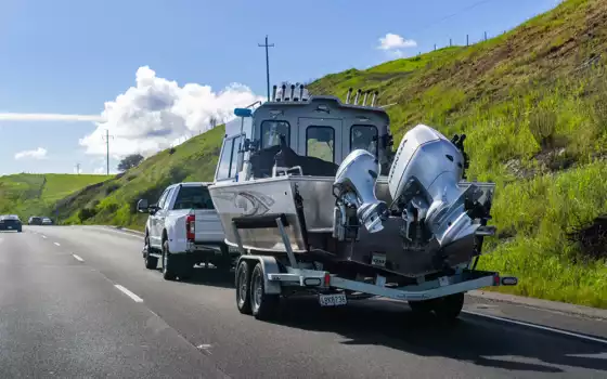 Photo of a car towing a boat on a trailer